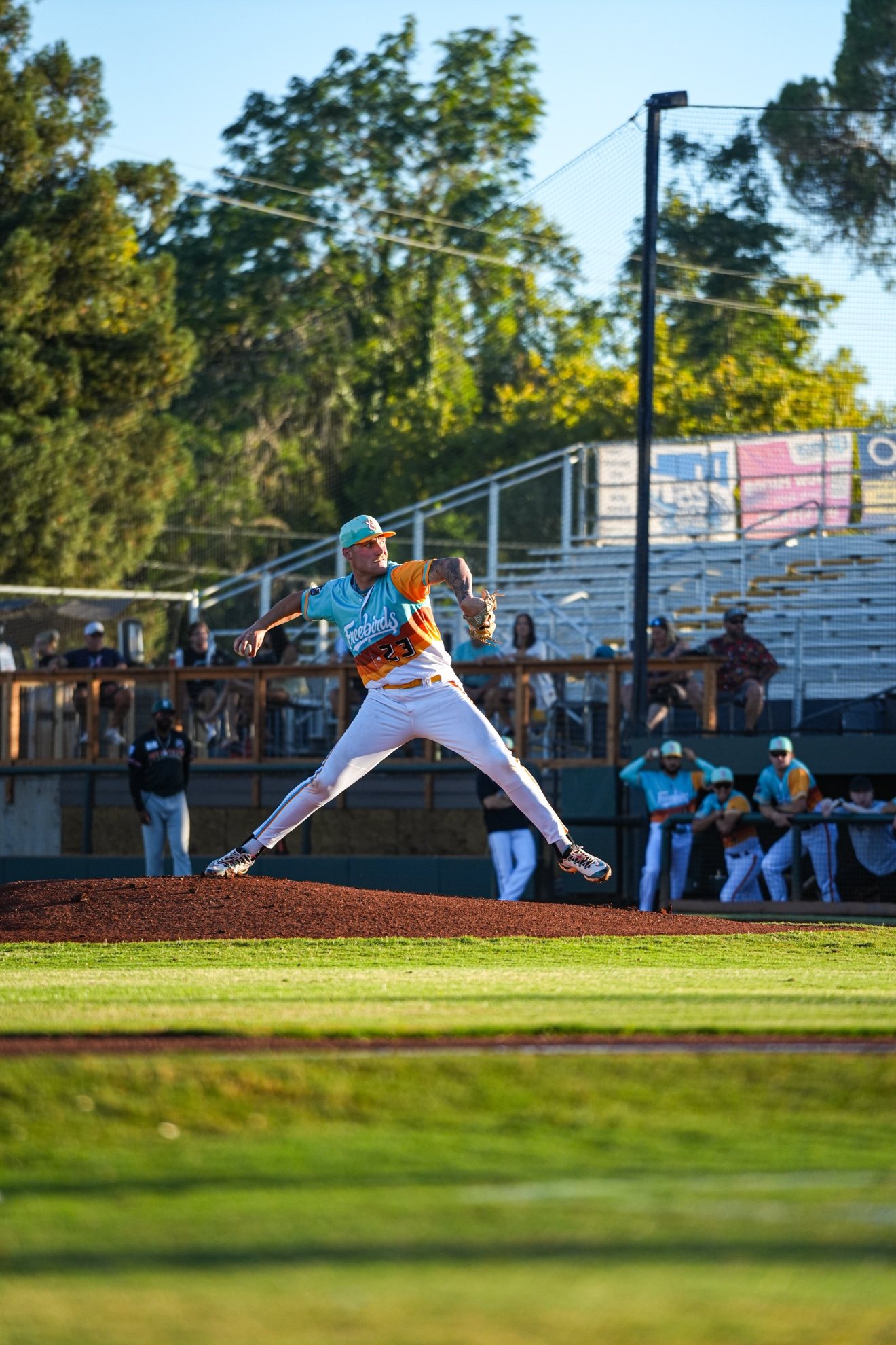 The Egghead Baseball coach on the mound, mid-delivery during a game